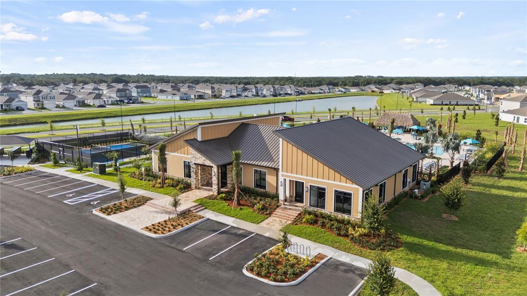 An aerial view shows a community clubhouse with a parking lot and a swimming pool — 5219 HAVEN VIEW DRIVE, CLERMONT, FL