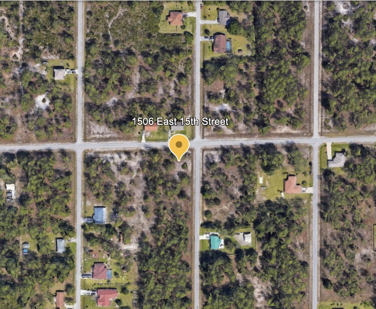 This is an aerial map view showing a vacant lot at a street intersection — 1506 E 15th Street, FL 33972, FL
