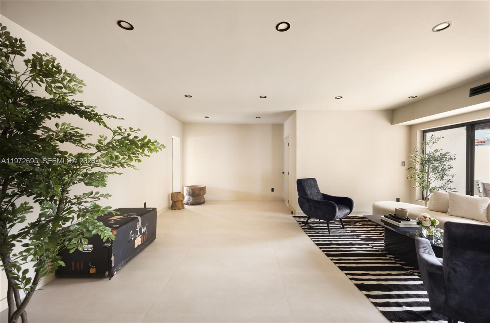 A modern living room features a striped rug, dark armchairs, and a white sofa — 2805 SW 4th Ave, Miami FL 33129, MIAMI, FL