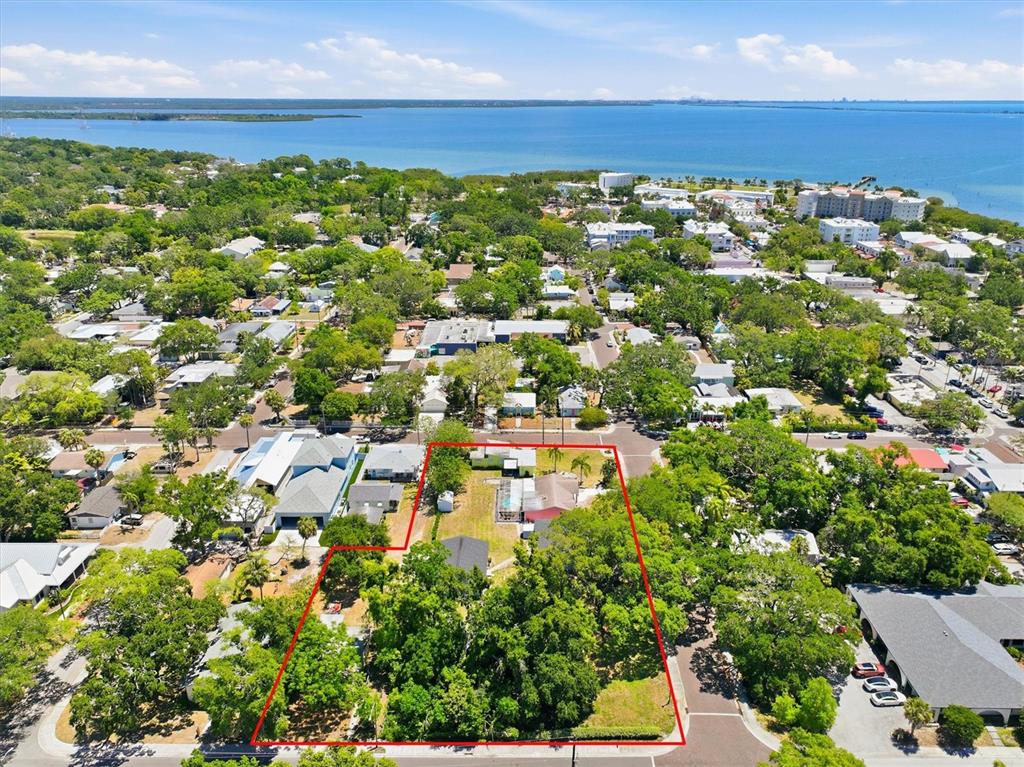An aerial view shows a large, tree-covered residential lot outlined in red near the water — 515 2ND STREET N, SAFETY HARBOR, FL
