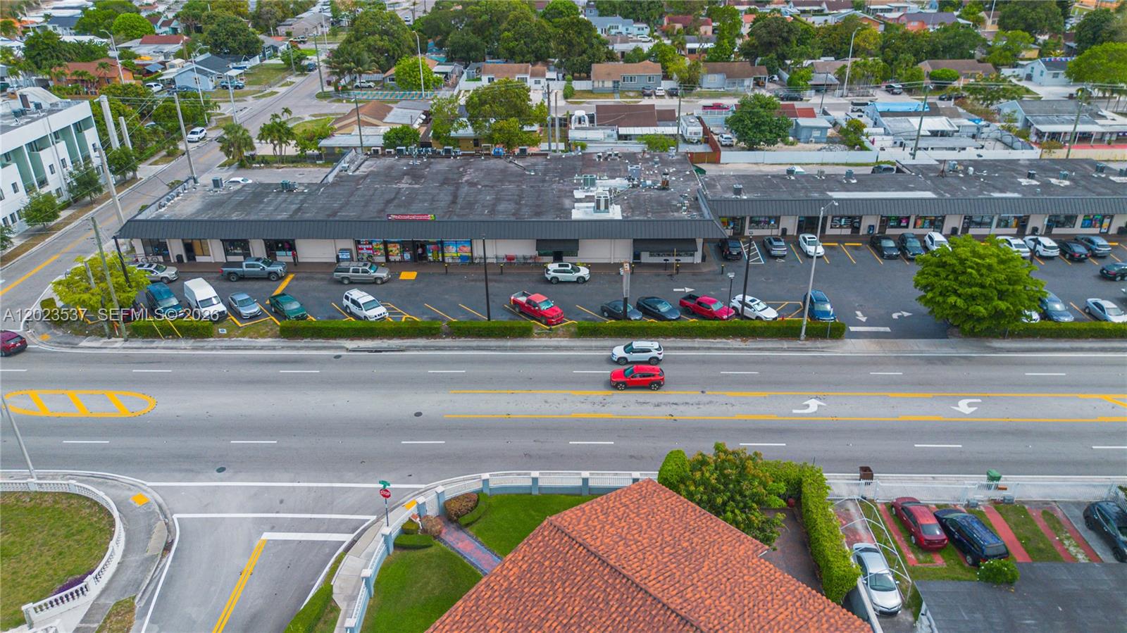 An aerial view shows a commercial strip mall with a parking lot and adjacent road — 652 East 9th Street, Hialeah FL 33010, HIALEAH, FL