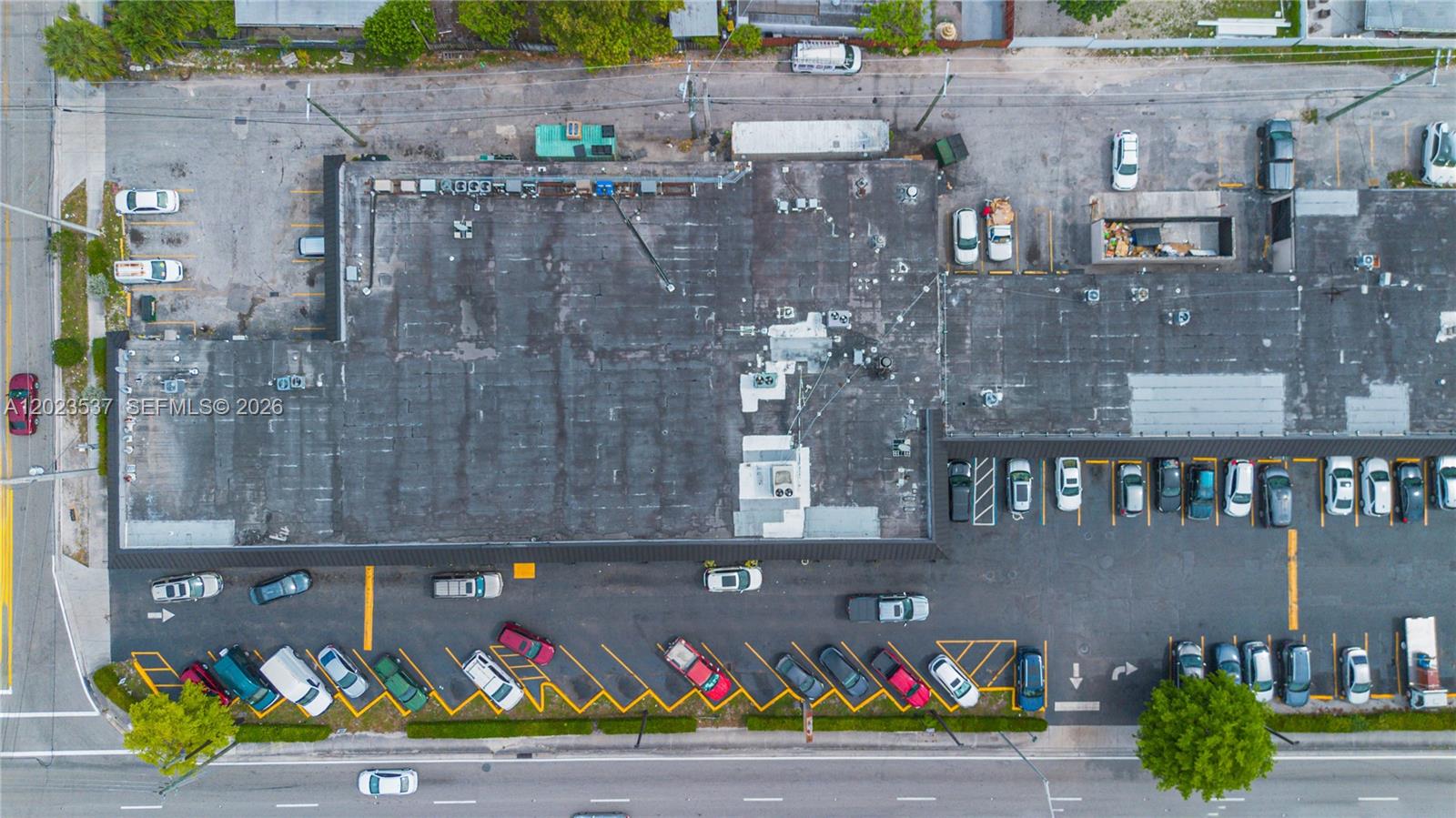 An aerial view shows a commercial building with a flat roof and a parking lot — 652 East 9th Street, Hialeah FL 33010, HIALEAH, FL