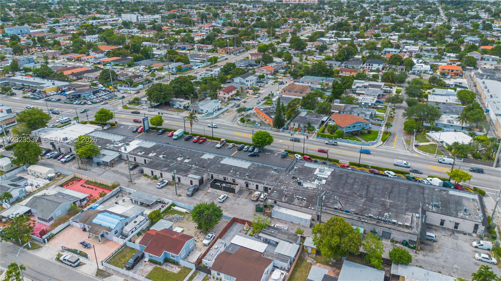 An aerial view shows a commercial building with a flat roof and surrounding residential neighborhood — 652 East 9th Street, Hialeah FL 33010, HIALEAH, FL