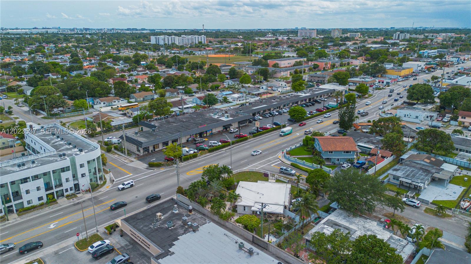 An aerial view shows a commercial strip mall along a busy road in a neighborhood — 652 East 9th Street, Hialeah FL 33010, HIALEAH, FL