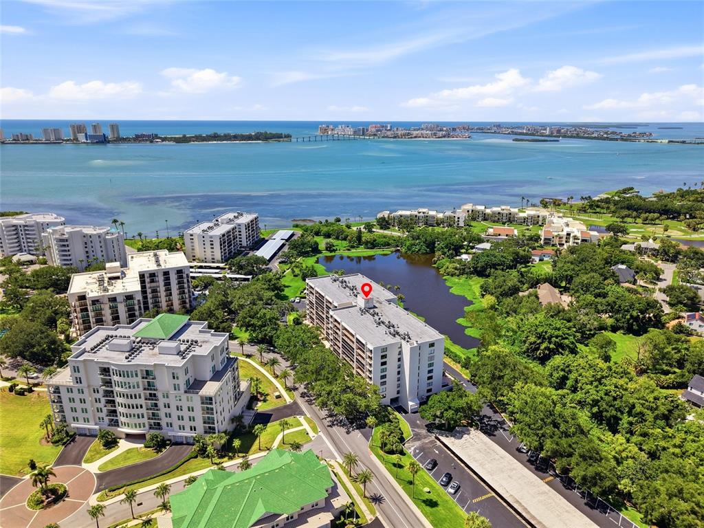 An aerial view shows a multi-story apartment building with a red location pin — 220 BELLEVIEW BOULEVARD UNIT 207, BELLEAIR, FL