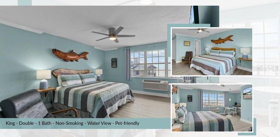This hotel room features a king bed, light blue walls, and a water view — 491 DOCK STREET, CEDAR KEY, FL