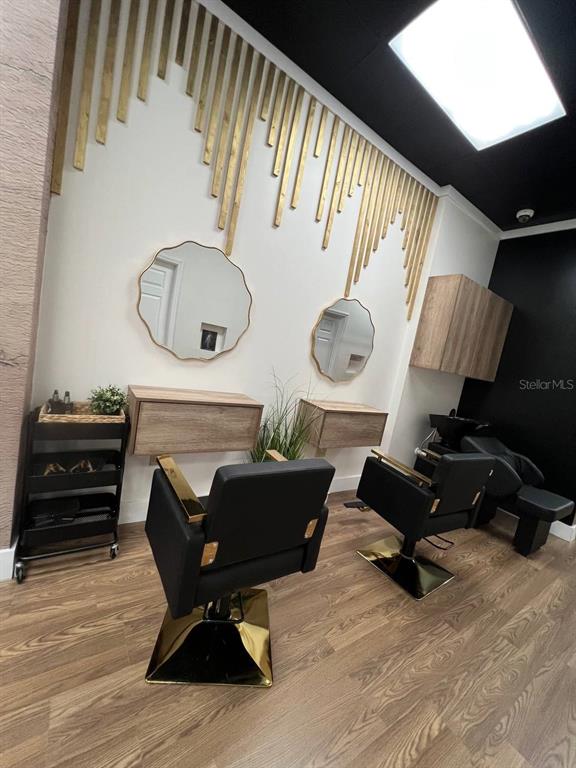 A hair salon features two styling stations with scalloped mirrors, wood accents, and black chairs — 14650 GATORLAND DRIVE UNIT 8, ORLANDO, FL