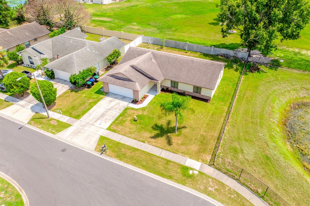 An aerial view of a single-story suburban house with a driveway and a fenced yard — 2790 MUSCATELLO STREET, ORLANDO, FL