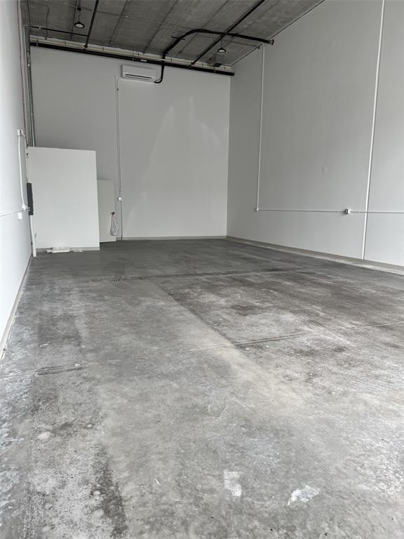 An empty industrial warehouse space with concrete floors, white walls, and an exposed ceiling — 5431 COMMUNICATIONS PARKWAY UNIT 20, SARASOTA, FL