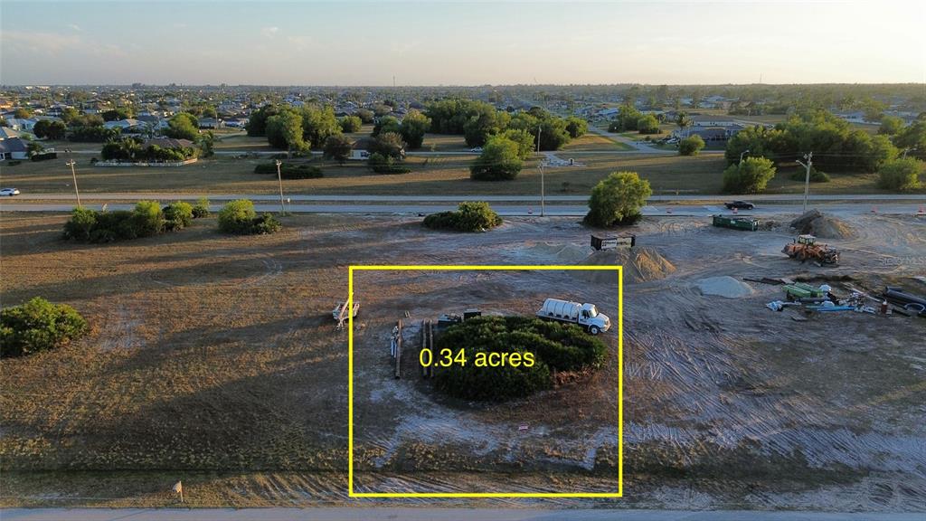 An aerial view shows a vacant, rectangular lot marked as 0.34 acres with construction equipment — 1508 NW 16TH TERRACE, CAPE CORAL, FL