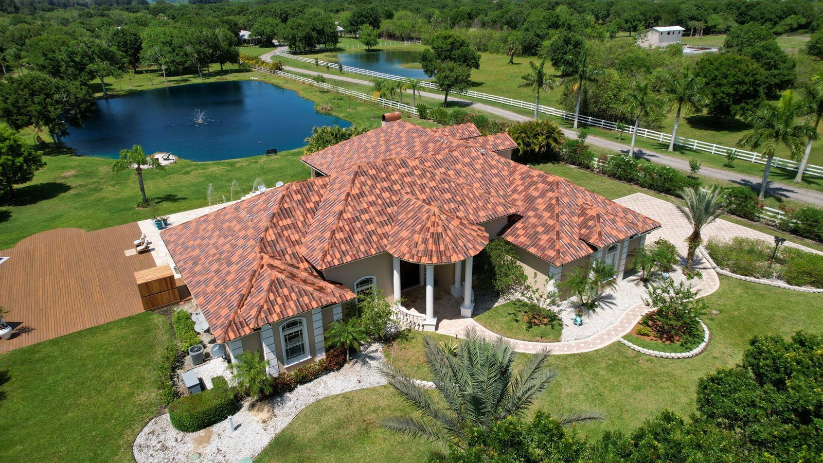 An aerial view of a house with a red tile roof, pool, and landscaped grounds — 6780 49th Street, Vero Beach FL 32967, VERO BEACH, FL