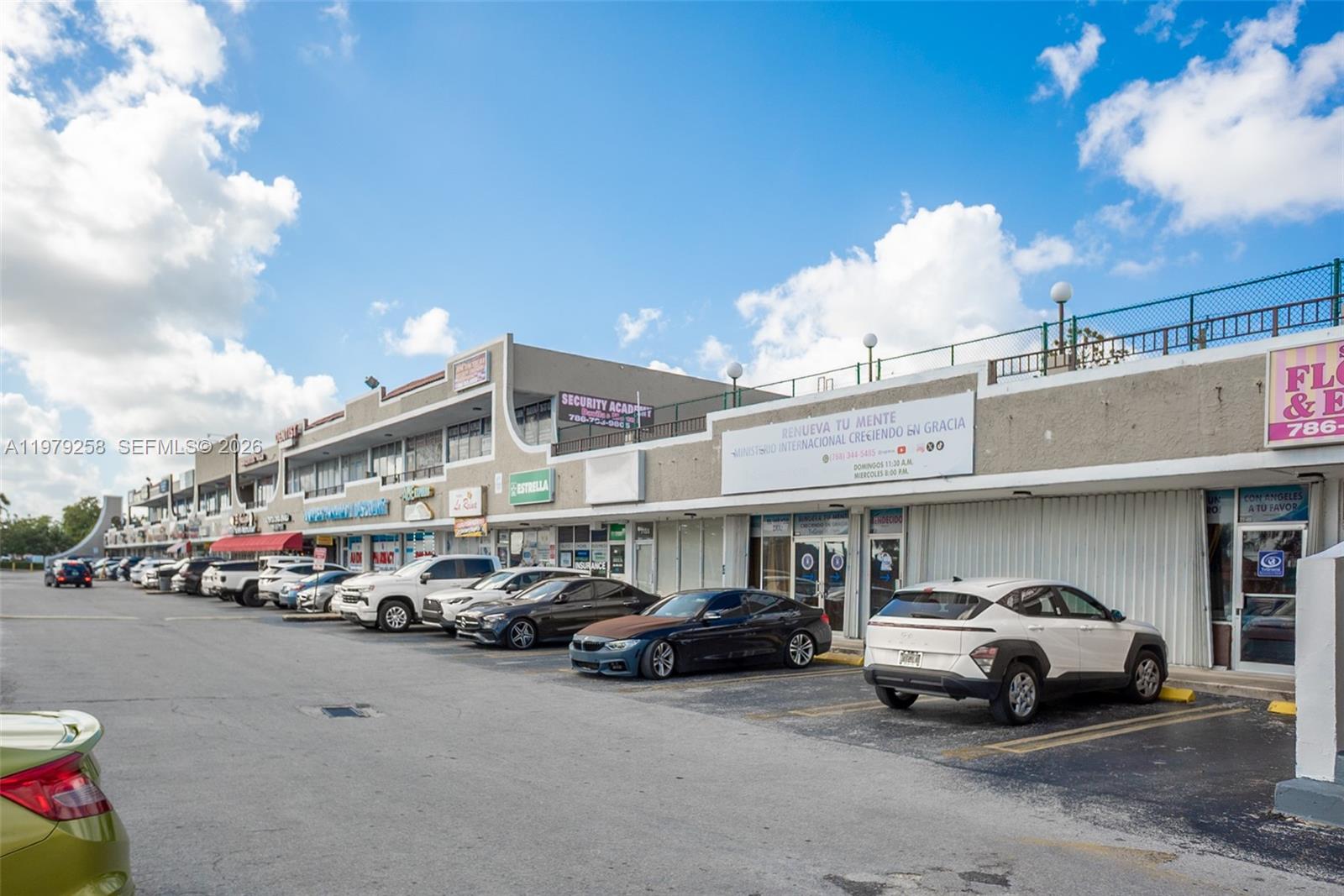 A strip mall with a parking lot in front under a blue sky — 7159 sw 8 st, Miami FL 33144, MIAMI, FL