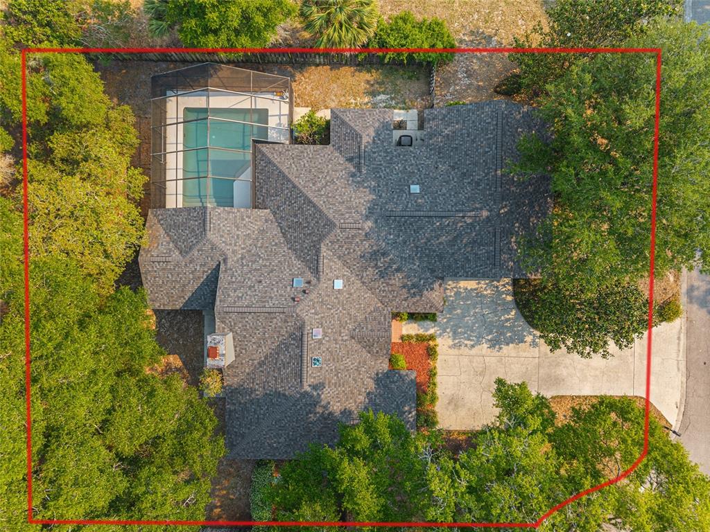 An aerial view shows a house with a screened-in pool and a large driveway — 2023 SW 76TH TERRACE, GAINESVILLE, FL
