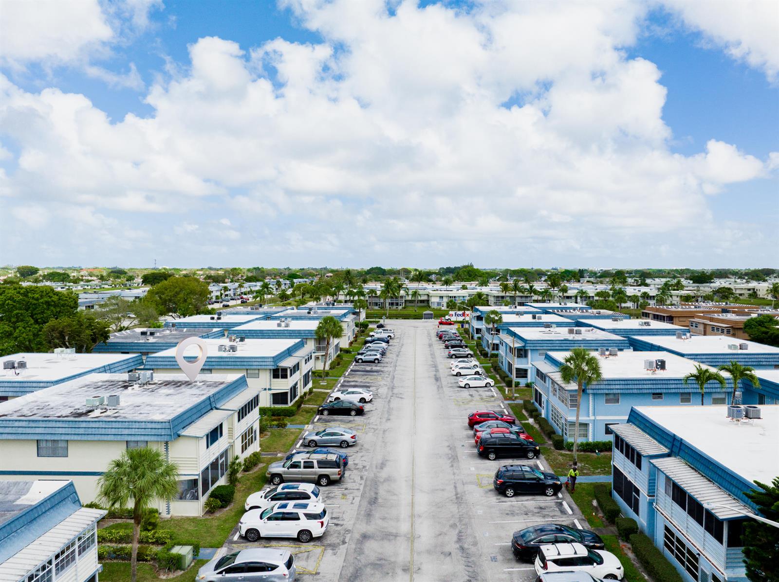 An aerial view shows a residential complex with blue-roofed buildings and a central parking lot — 233 Brittany E, Delray Beach FL 33446, DELRAY BEACH, FL
