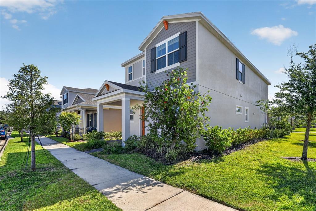 A two-story house with gray siding and a covered entryway sits beside a sidewalk — 762 MIDDLETON STREET, DEBARY, FL