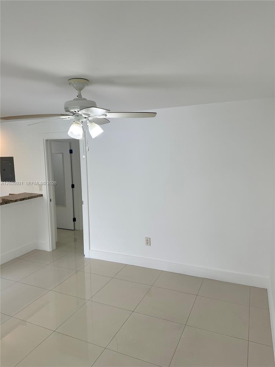 A room with white walls, light-colored tile flooring, and a ceiling fan with lights — 3071 SW 27th Ave # 25, Miami FL 33133, MIAMI, FL