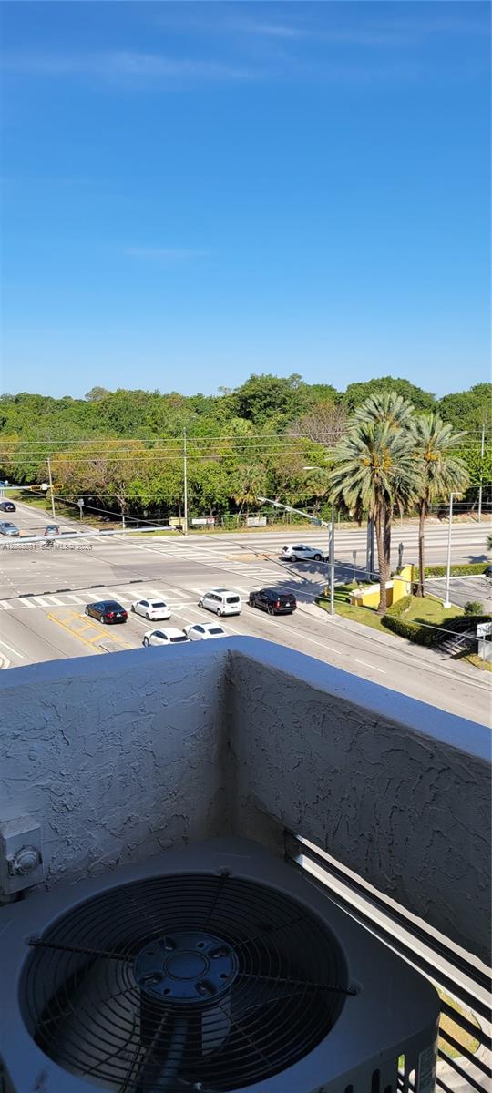 An elevated view from a balcony shows an air conditioning unit overlooking a road intersection — 13499 Biscayne Blvd # 511, North Miami FL 33181, NORTH MIAMI, FL