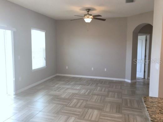 A multi-story townhouse exterior features tan stucco, stone veneer, and several attached garage doors — 7001 INTERBAY BOULEVARD UNIT 235, TAMPA, FL