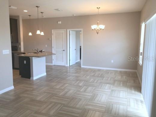 A tan two-story building exterior features a dark front door and a concrete walkway — 7001 INTERBAY BOULEVARD UNIT 235, TAMPA, FL