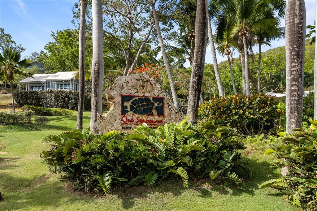 A stone sign for Club Seabourne Hotel sits in a grassy area with palm trees — 1 SEABOURNE, CULEBRA, PR