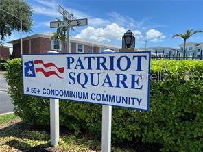 A sign for Patriot Square, a 55+ condominium community, stands in front of a hedge — 3595 40TH AVENUE S UNIT 2, ST PETERSBURG, FL