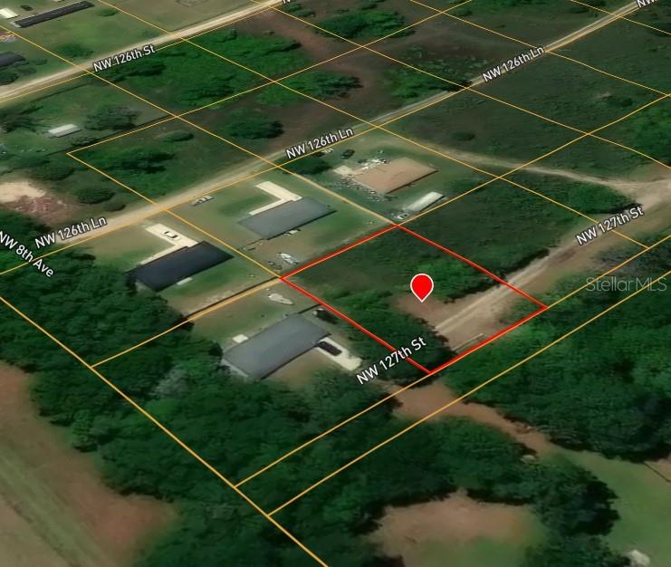 This is an aerial map view showing a vacant, rectangular lot outlined in red — NORTHWEST 127TH STREET, CITRA, FL