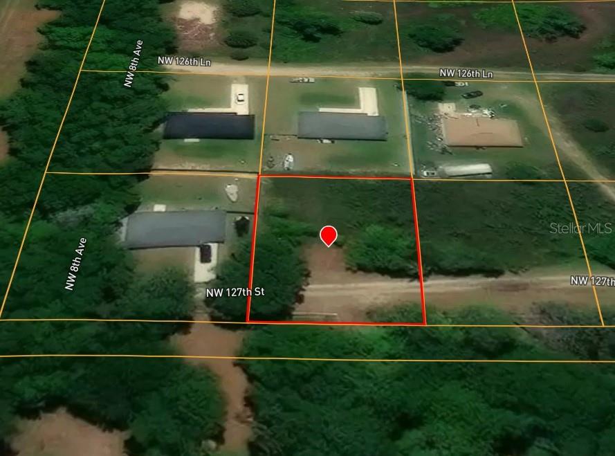 An aerial view shows a vacant, rectangular lot outlined in red within a residential area — NORTHWEST 127TH STREET, CITRA, FL