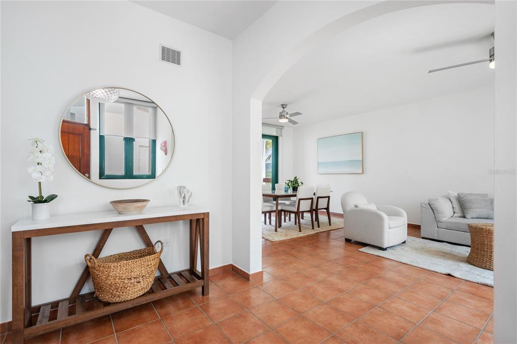 A foyer with a console table and mirror leads into a living and dining area — 1601 RIO MAR VILLAGE UNIT 1601, RIO GRANDE, PR
