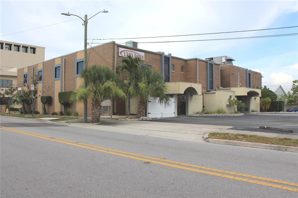 A two-story brick commercial building with palm trees and a parking lot in front — 1253/1255 PARK STREET, CLEARWATER, FL