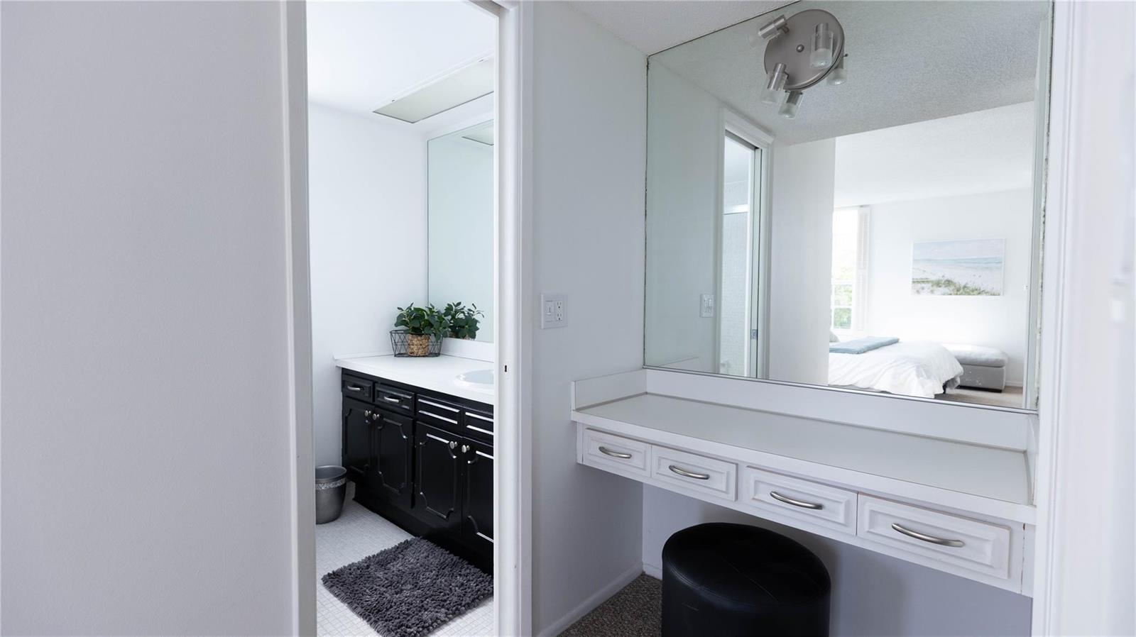 A bathroom with a black vanity and a separate white vanity area with a mirror — 3100 N Course Lane # 510, Pompano Beach FL 33069, POMPANO BEACH, FL