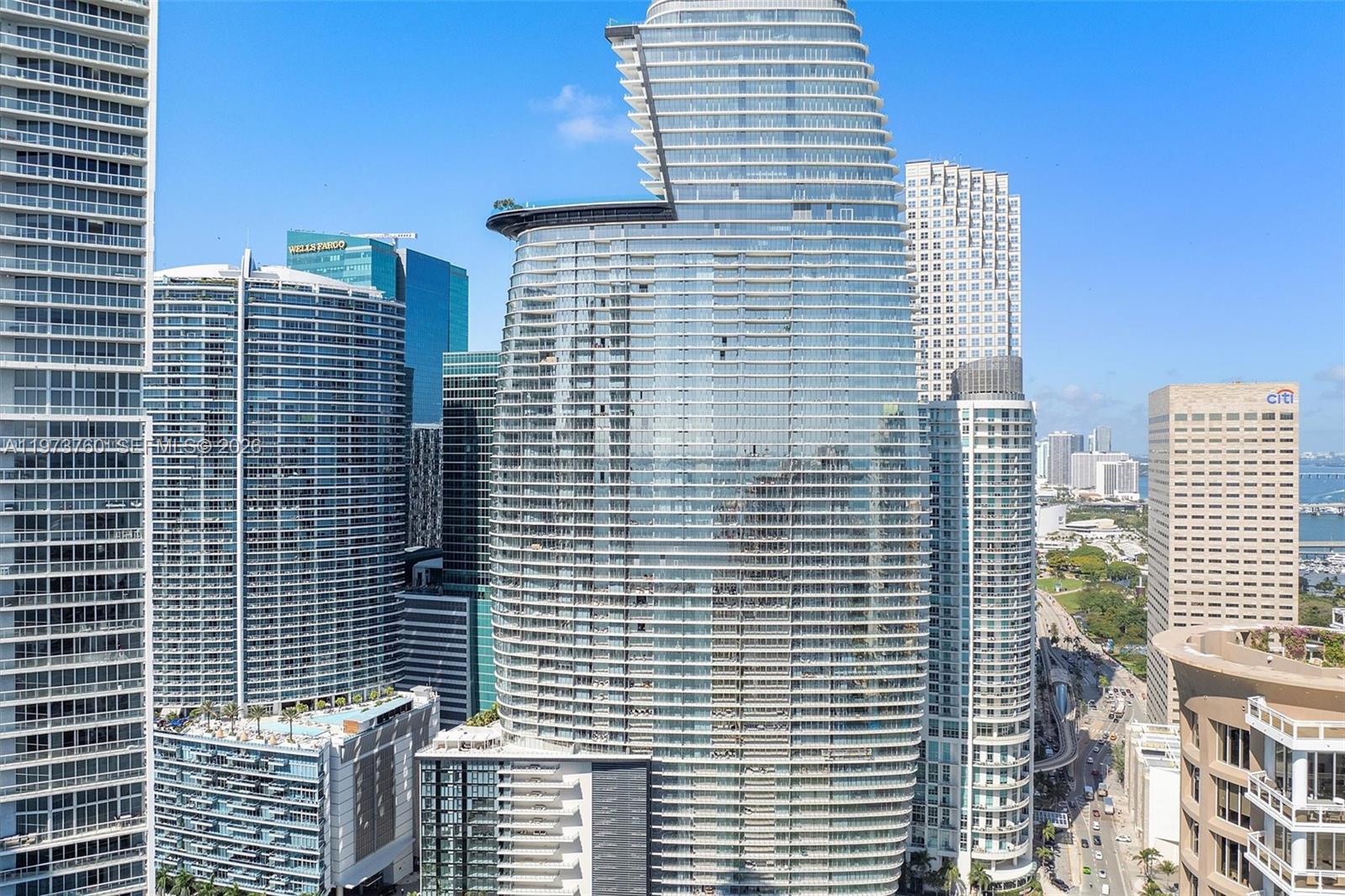 An exterior view of several modern high-rise glass skyscrapers in a dense urban city — 300 Biscayne Blvd Way # 903, Miami FL 33131, MIAMI, FL
