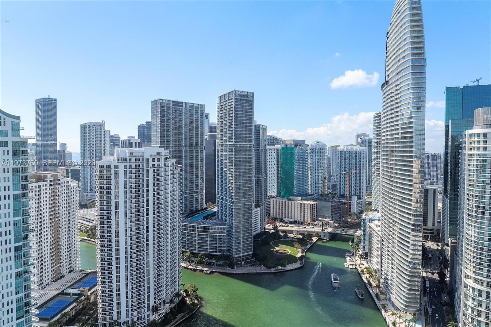 An aerial view of the Miami skyline featuring high-rise buildings along a river — 300 Biscayne Blvd Way # 903, Miami FL 33131, MIAMI, FL