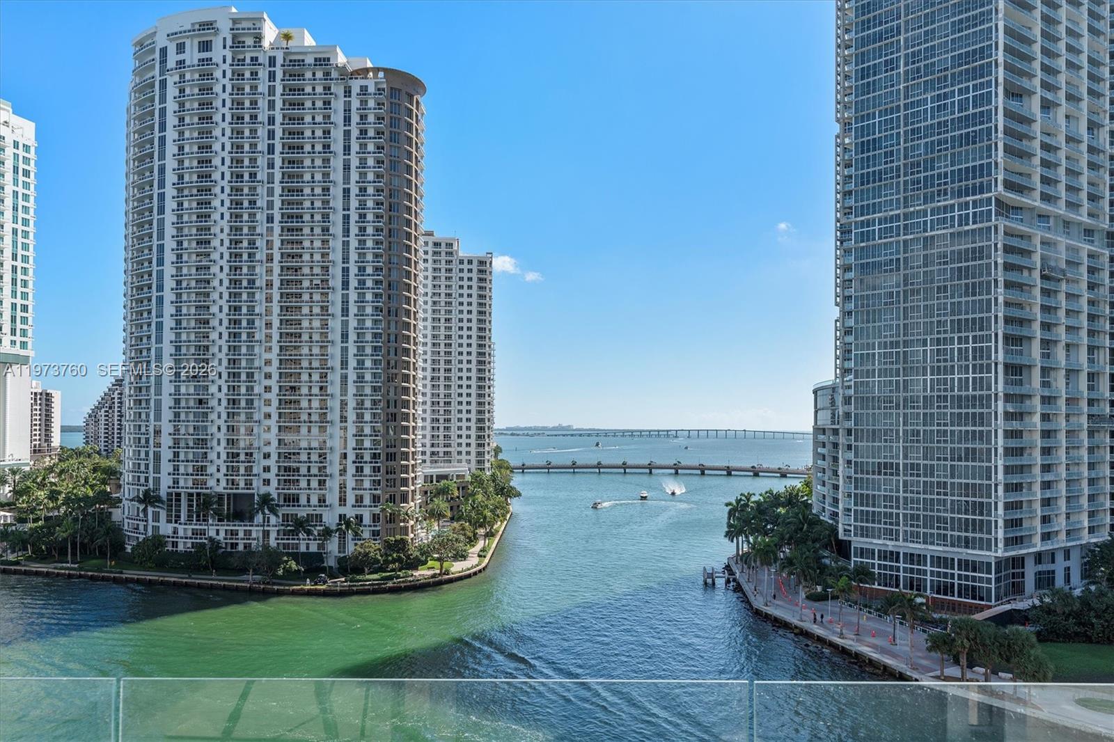 An elevated view shows a waterway between two high-rise apartment buildings and a distant bridge — 300 Biscayne Blvd Way # 903, Miami FL 33131, MIAMI, FL