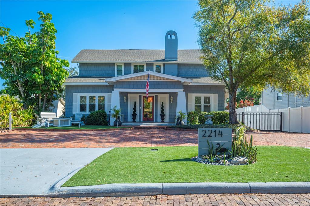 A two-story blue house with a brick driveway and a front lawn — 2214 COVENTRY AVENUE, LAKELAND, FL