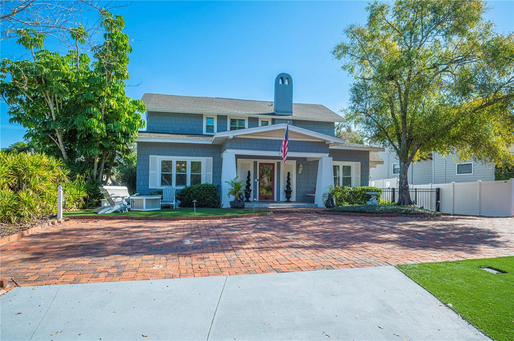 A two-story gray house with a brick driveway and a front porch — 2214 COVENTRY AVENUE, LAKELAND, FL