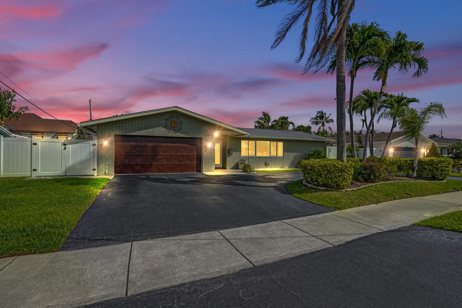 A backyard features a swimming pool, a covered patio, and a gazebo near a white fence — 3001 NE 45th Street, Lighthouse Point FL 33064, LIGHTHOUSE POINT, FL