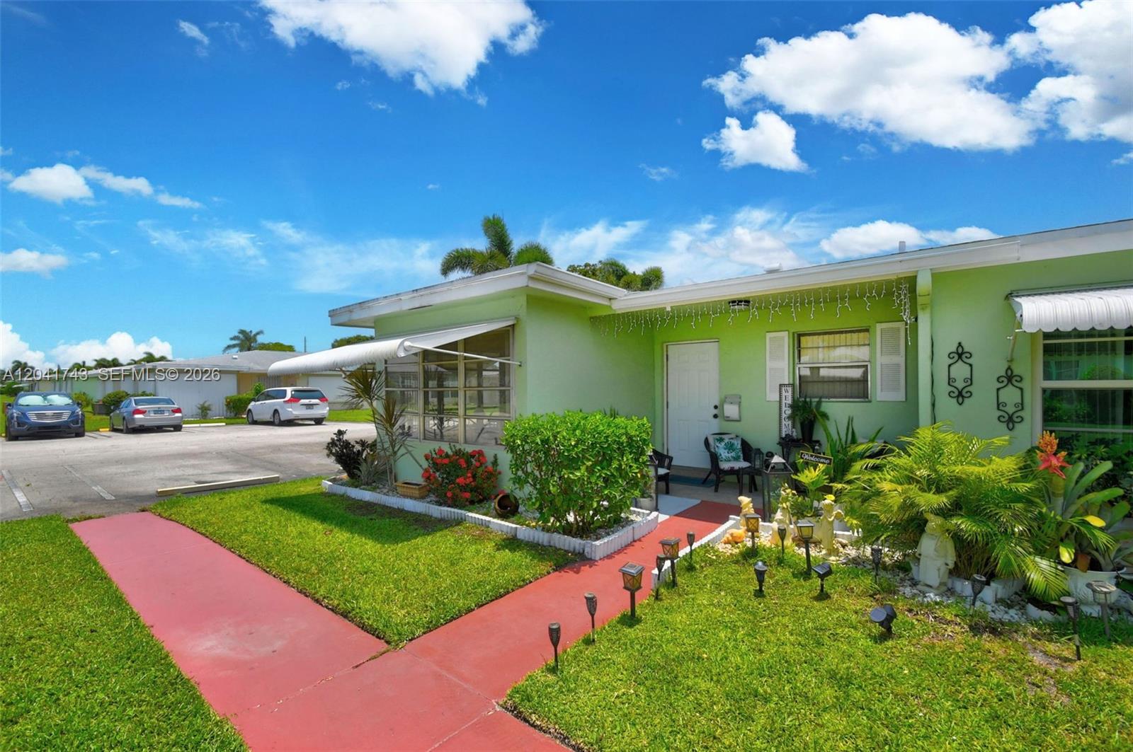 A light green single-story house features a red walkway and a small front garden — 3241 Ridge Hill Rd, Boynton Beach FL 33435, BOYNTON BEACH, FL