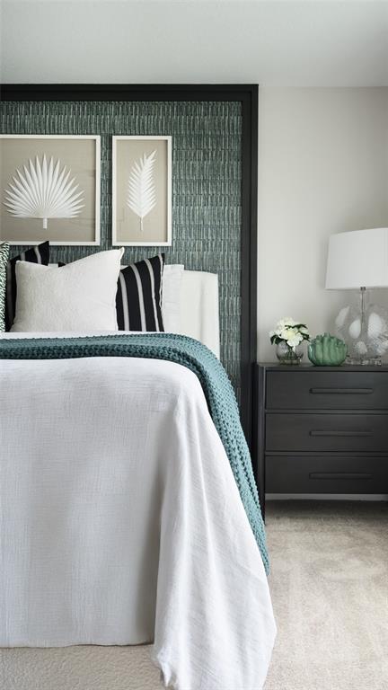 A bedroom features a bed with a teal textured headboard, white bedding, and a nightstand — 6059 PRAIRIE RUN, HAINES CITY, FL