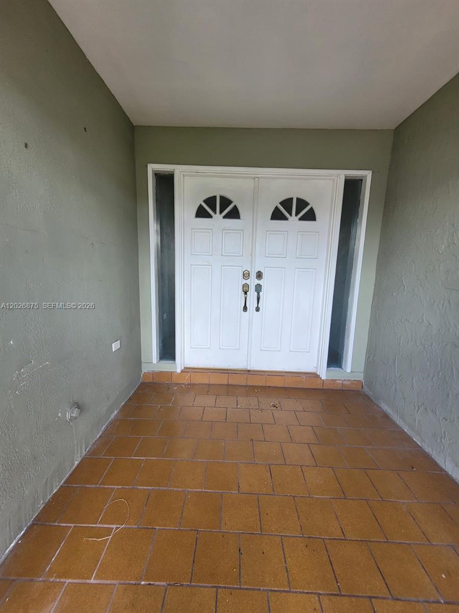 A covered entryway features a double front door with glass inserts and tiled flooring — 2438 SW 109th Ct, Miami FL 33165, MIAMI, FL