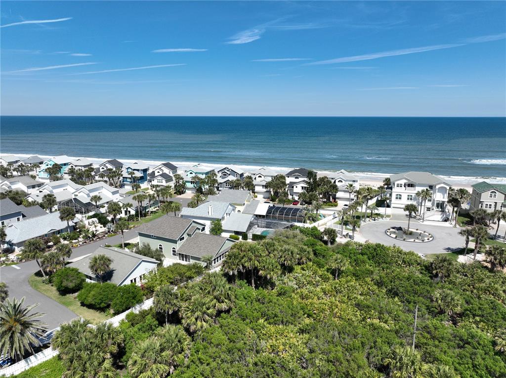 An aerial view shows a coastal neighborhood with houses situated near the ocean — 11 MAHOE DRIVE N, PALM COAST, FL