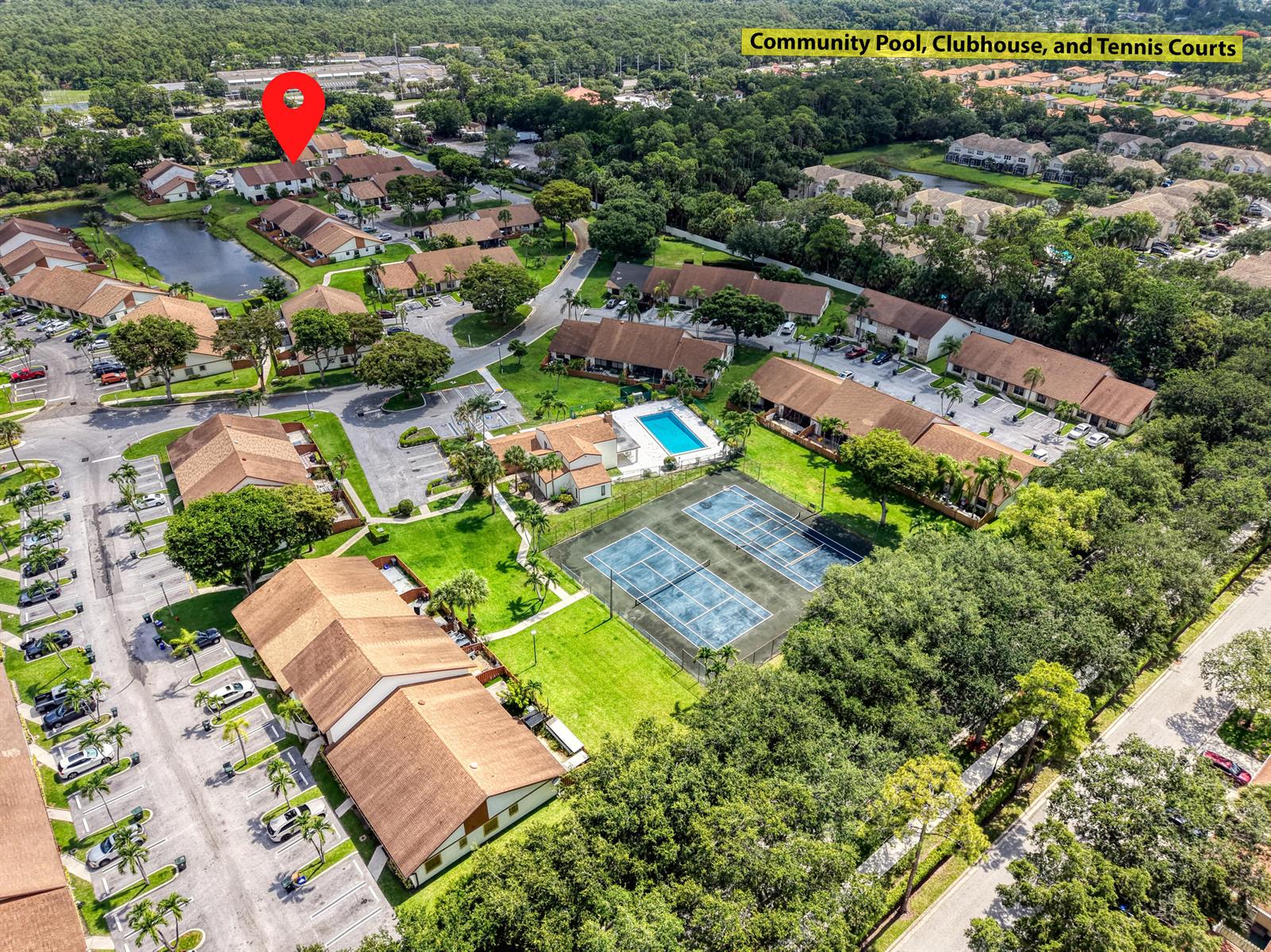 Aerial view of a residential community featuring a swimming pool, tennis courts, and clubhouse — 1030 Parkside Green Drive # A, FL 33415, FL