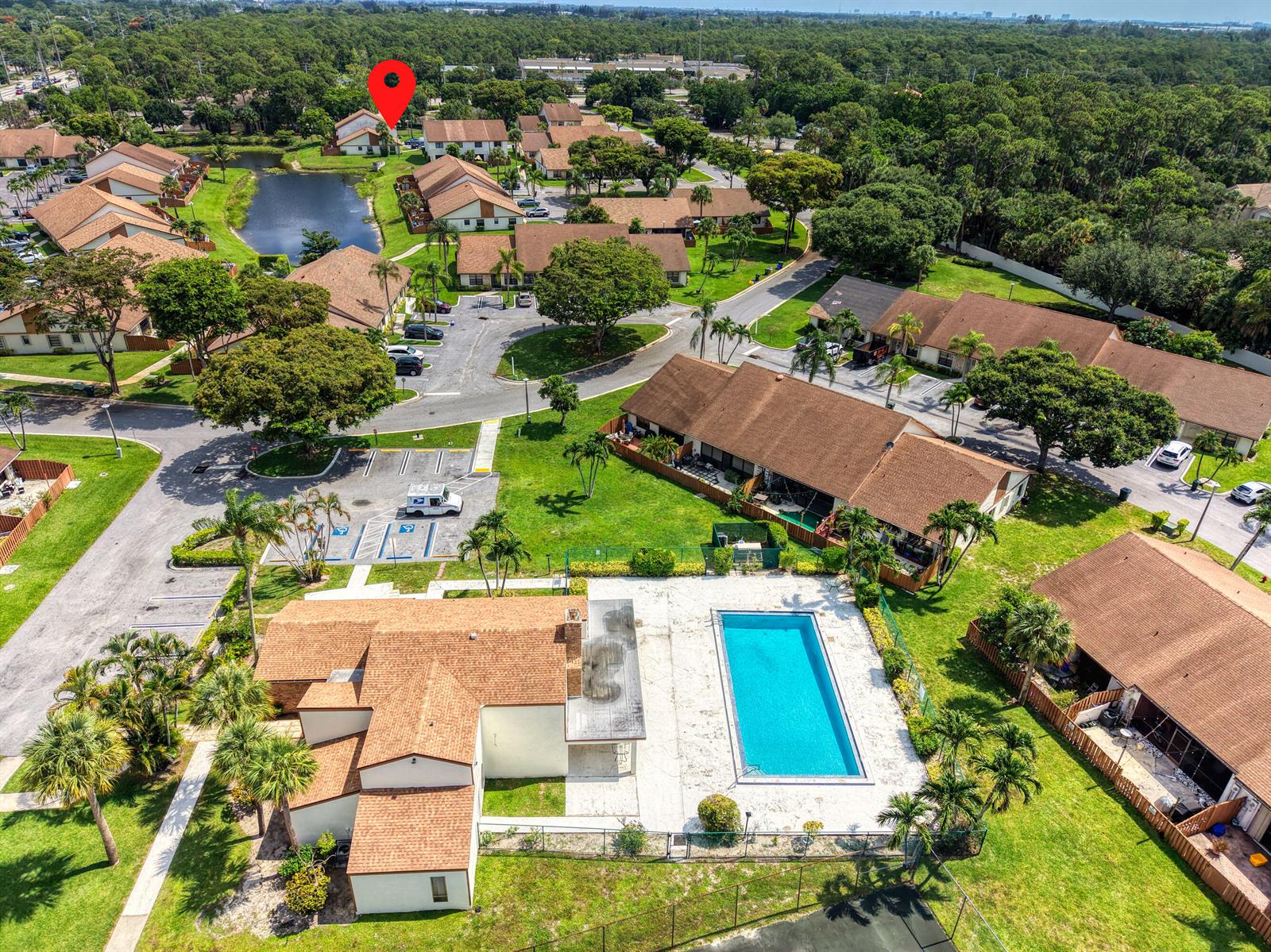 An aerial view shows a residential complex with a swimming pool and surrounding buildings — 1030 Parkside Green Drive # A, FL 33415, FL