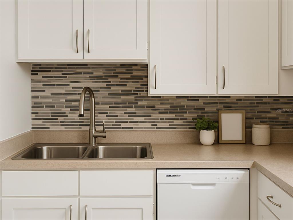 A kitchen features white cabinets, a stainless steel sink, and a multi-colored linear tile backsplash — 2359/2361 CHESTNUT HILLS DRIVE, LAKELAND, FL
