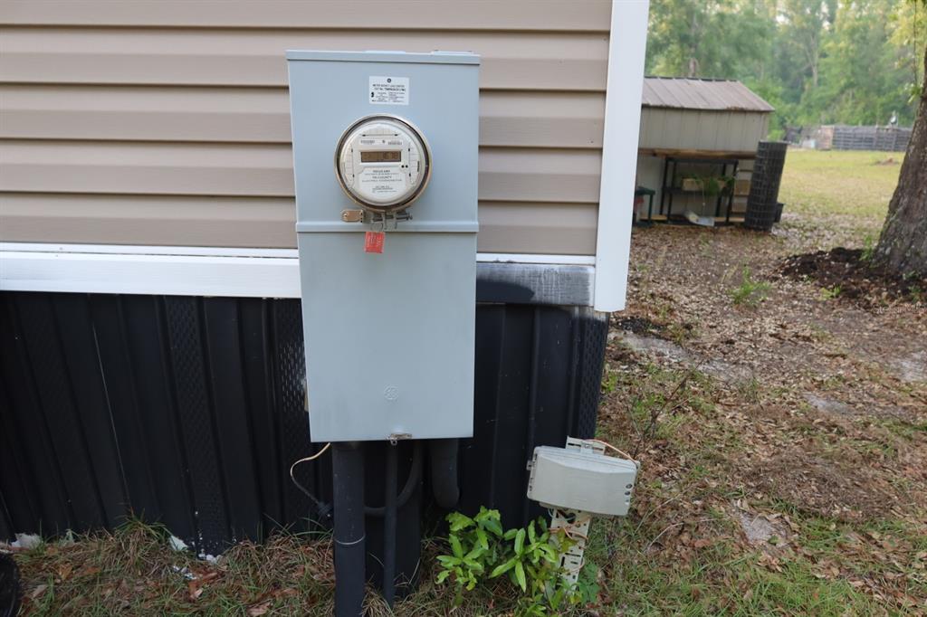 An exterior view shows an electrical meter box mounted on the side of a house — 11533 E US 90, MADISON, FL