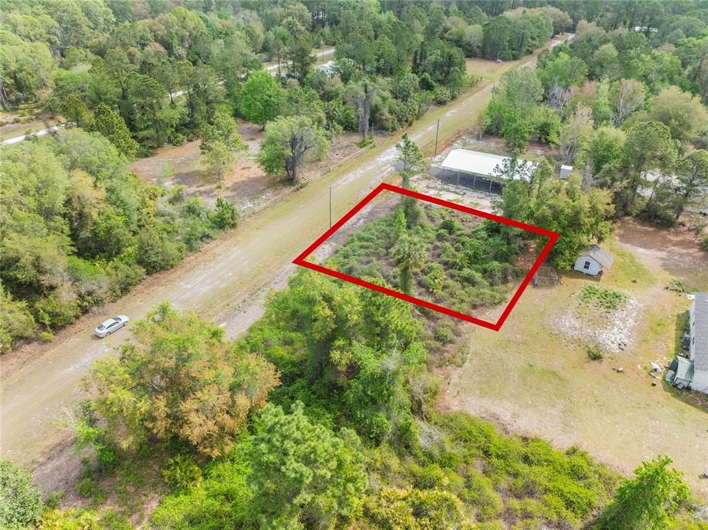 An aerial view shows a rectangular plot of land outlined in red near a dirt road — 515 GARDENIA AVENUE, GEORGETOWN, FL