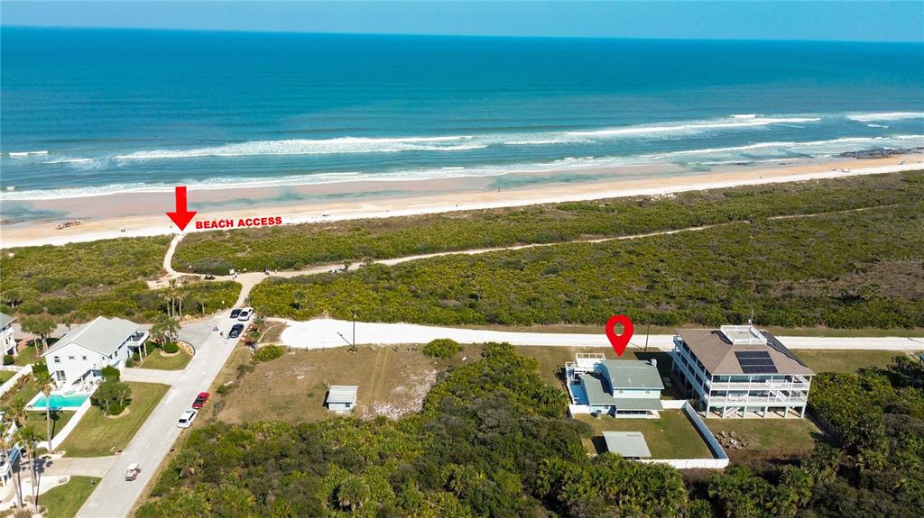 An aerial view shows a coastal house with a red location pin near the beach — 26 OCEAN VISTA LANE, PALM COAST, FL