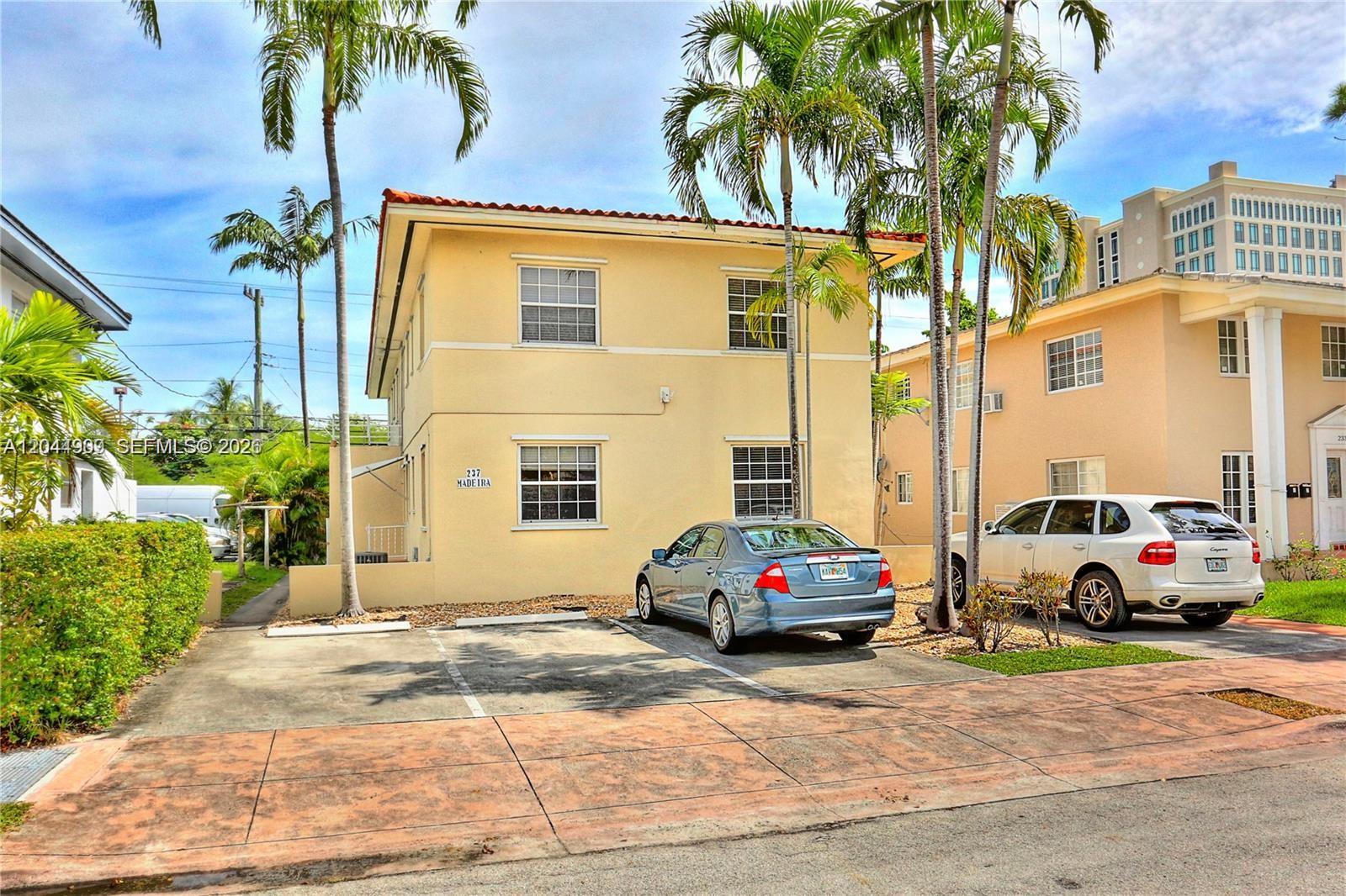 A two-story yellow stucco building with a tile roof and two parked cars in front — 237 Madeira Ave # 3, Coral Gables FL 33134, CORAL GABLES, FL