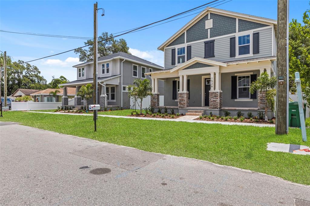 Two modern two-story houses with gray siding and front porches sit along a residential street — 1526 W ARCH STREET, TAMPA, FL