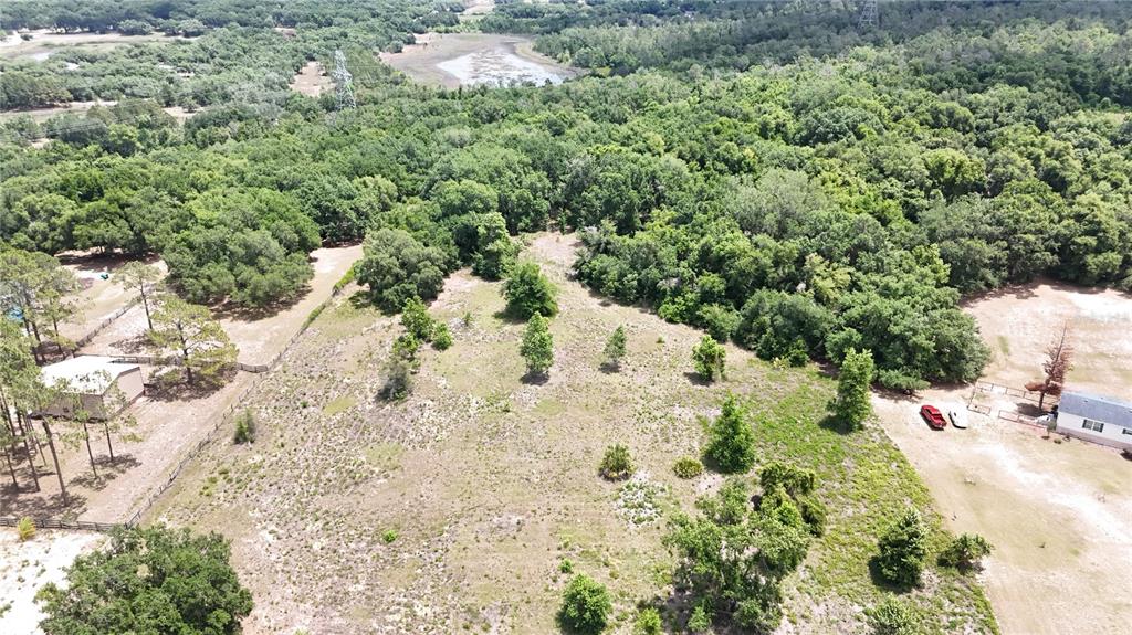 An aerial view shows a large, grassy, partially wooded lot with a small building nearby — SONOMA RIDGE ROAD, CLERMONT, FL