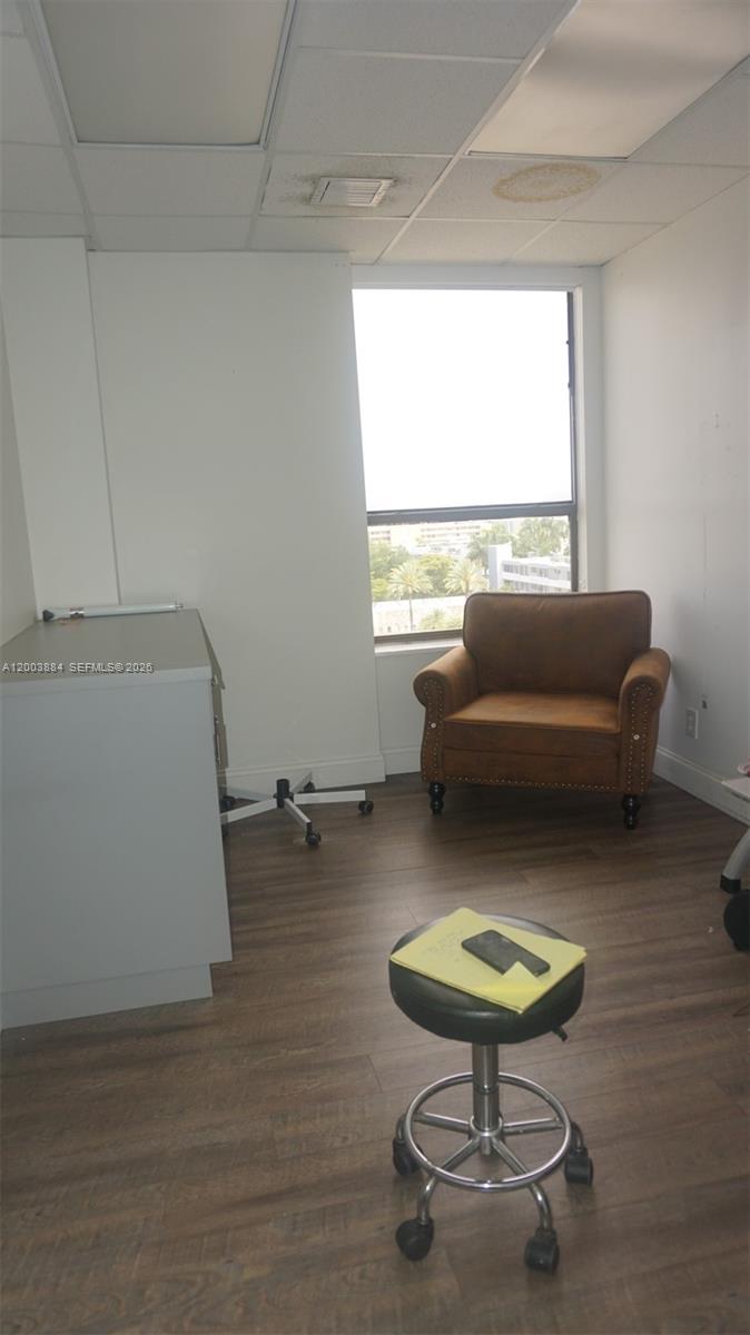 An office room features a brown armchair, a rolling stool, and a window with views — 1250 E Hallandale Beach Blvd, Hallandale Beach FL 33009, HALLANDALE BEACH, FL